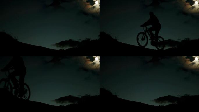 夜间骑自行车的人在月光下骑自行车