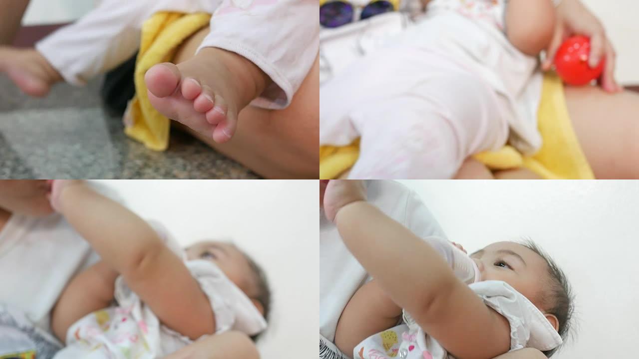 婴儿奶瓶喂养并躺在母亲腿上