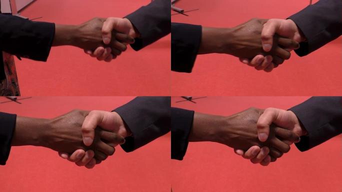 红色背景上的男女握手