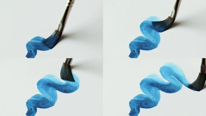 用蓝色水彩画笔在纸上画画