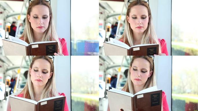 美丽的女人坐在电车上看书