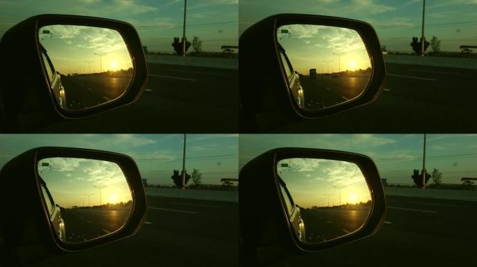 从带日落的后视镜看到的高速公路旅行