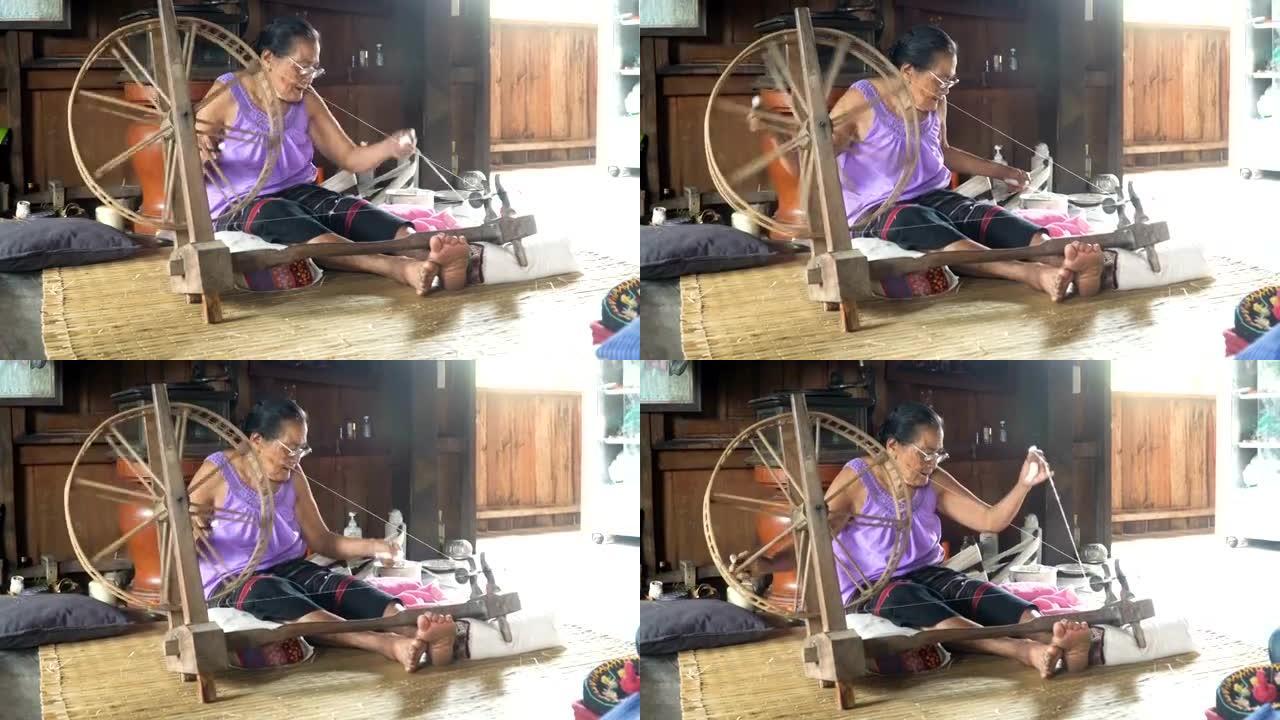泰国祖母在家里选址并编织纺织品