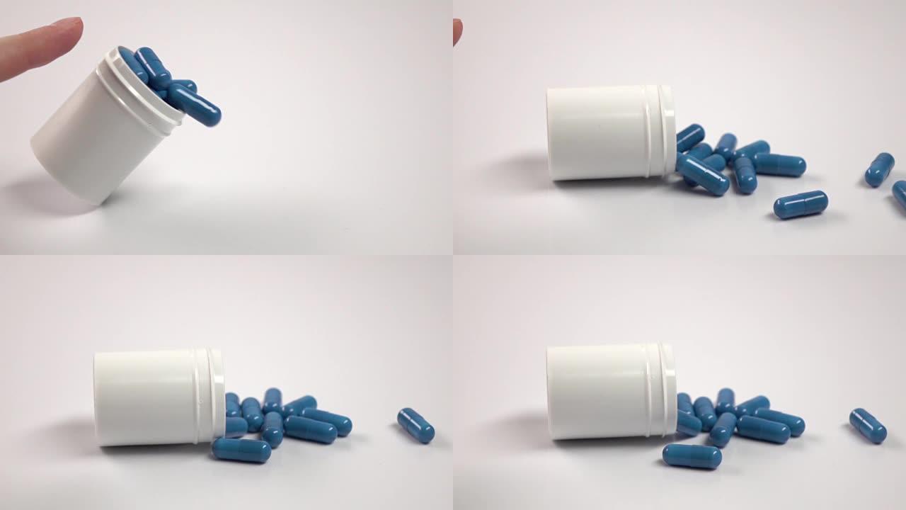 蓝色药丸从药瓶中掉出来，白色，特写，慢动作