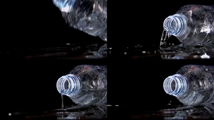 慢: 一个塑料瓶落在黑色桌子上，水从桌子上倒出