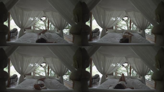 熟睡的女孩醒了。天篷下的浪漫床。森林里的卧室。女人伸懒腰，打哈欠，在床上醒来。醒来，迅速起床。睡过头