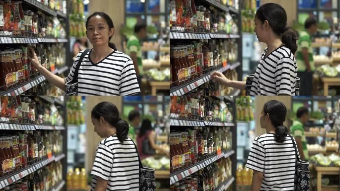 泰国清迈-2015年5月-亚洲女孩，女人在超市岛散步，寻找和购物酱汁