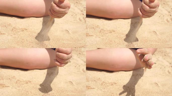女孩正在沙滩上浇沙子，慢动作。