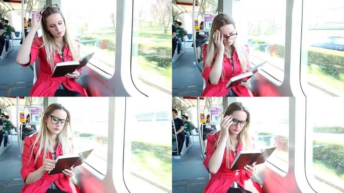 美丽的女人坐在电车看书，并放置她的眼镜