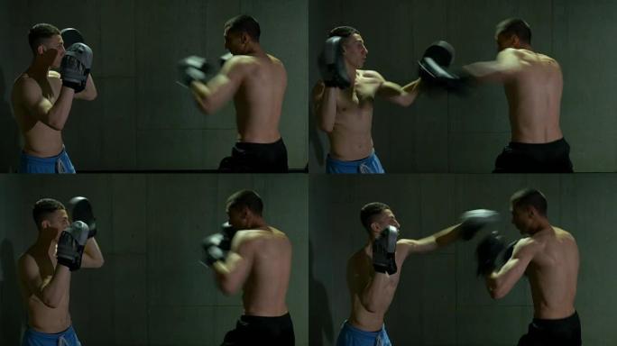 两个男子跆拳道拳手在拳击工作室集中和决心训练