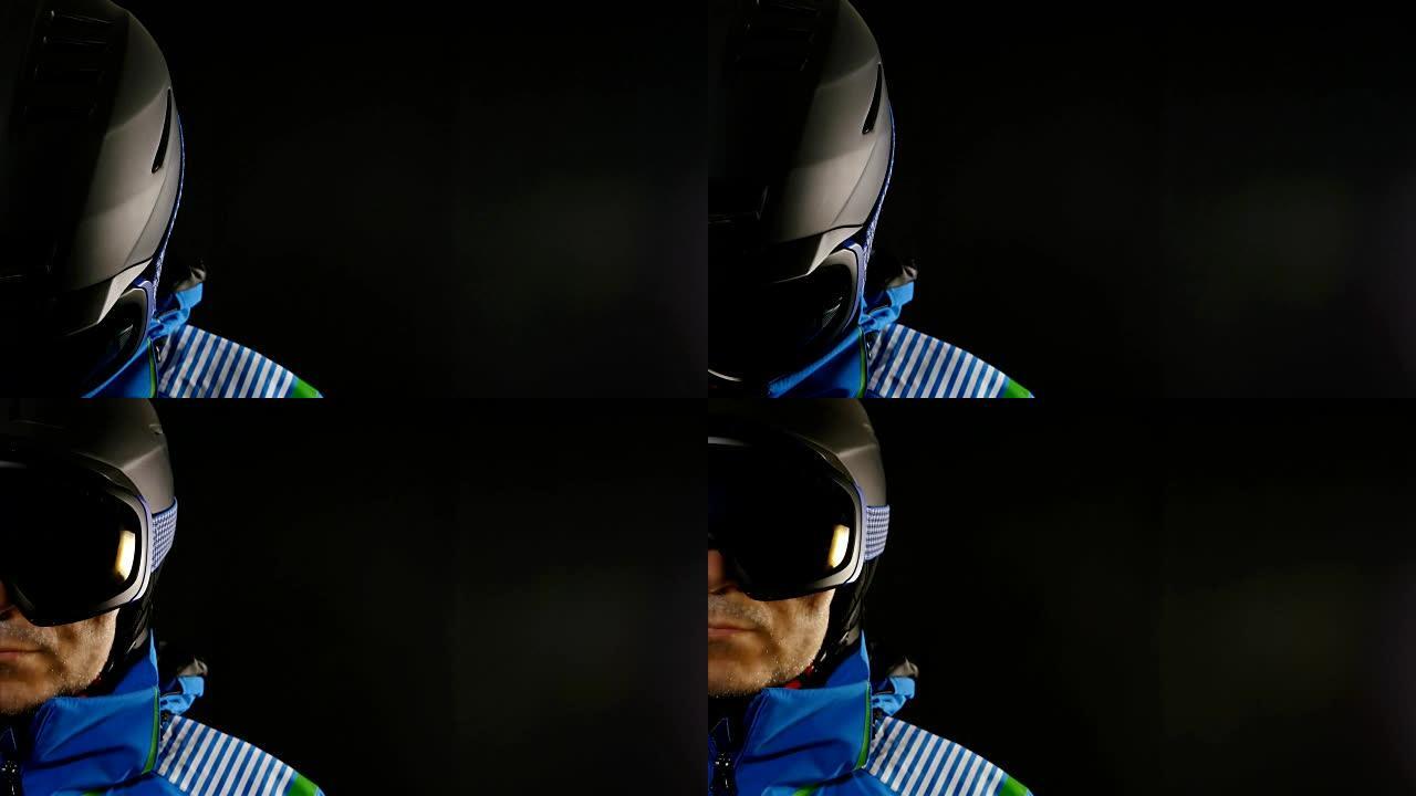 黑色背景上戴着眼镜的滑雪者/滑雪者的半脸肖像
