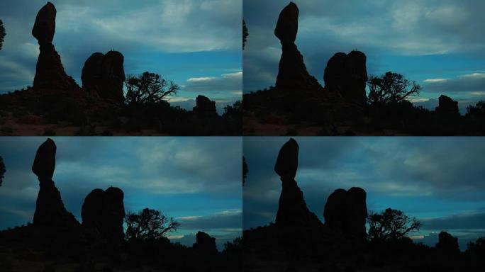 美国犹他州摩押附近的拱门国家公园，顶部有登山者的平衡岩石的延时拍摄