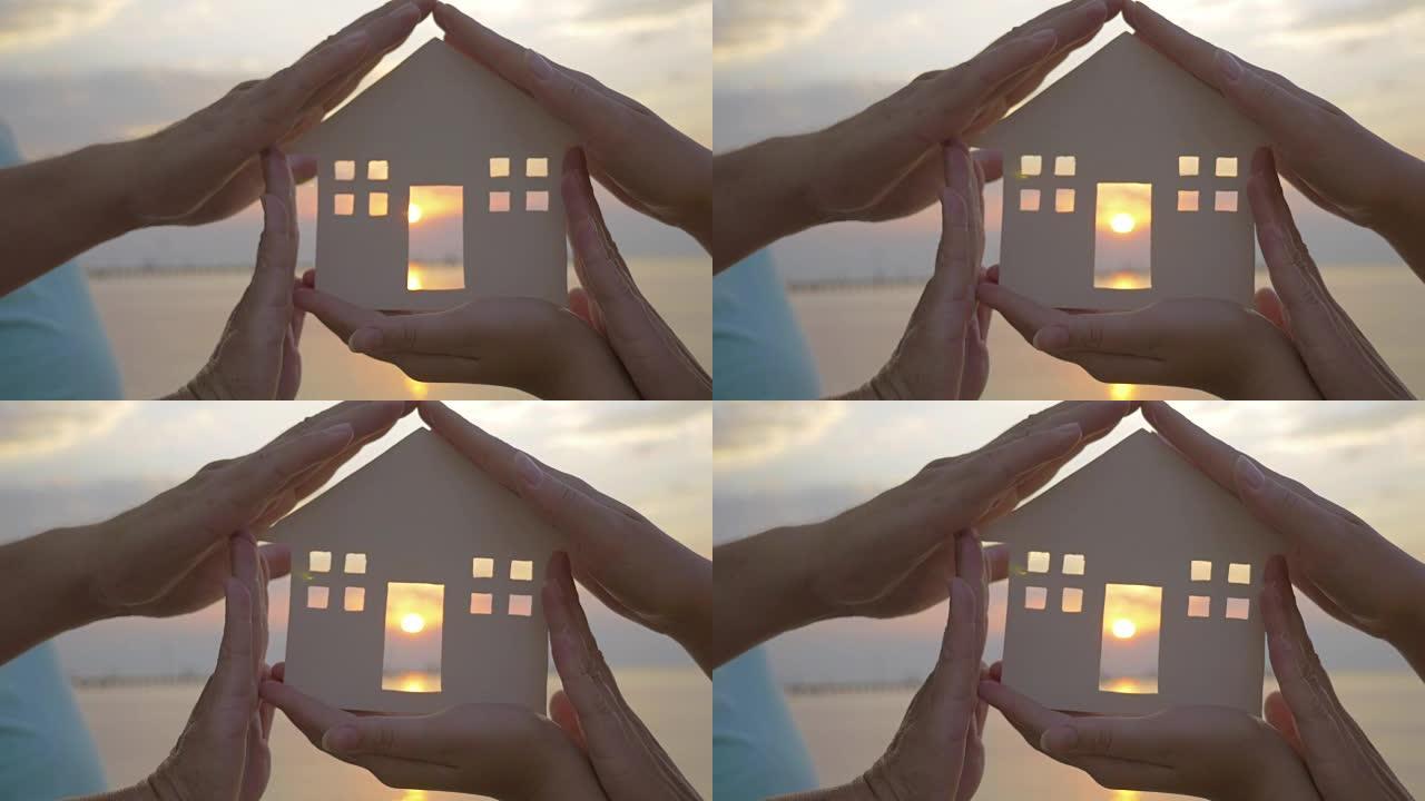 双手握着房子的轮廓，抵御阳光