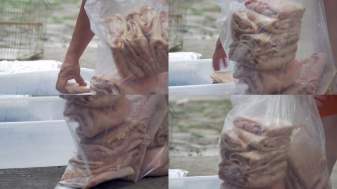 男人将未煮熟的猪皮装进塑料袋中，用于chicharroone