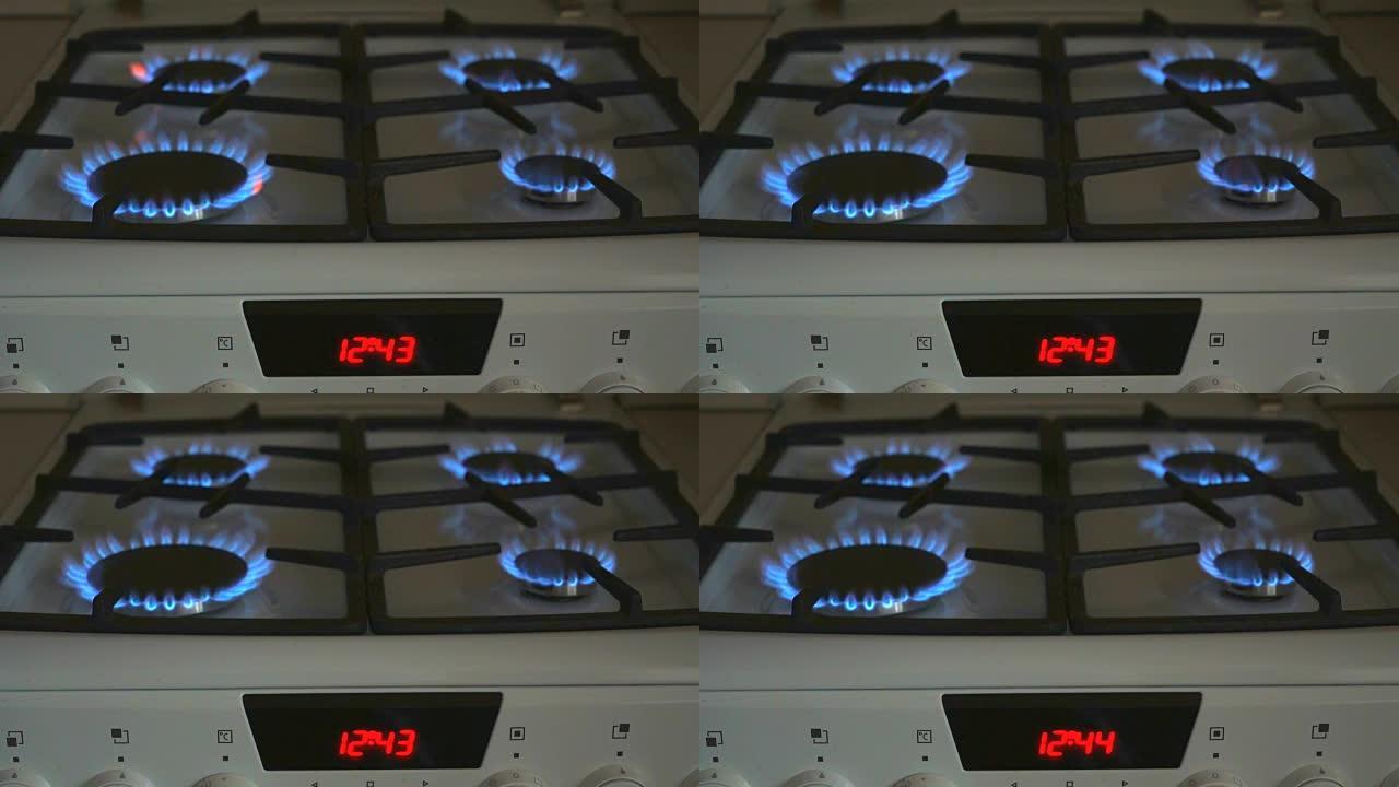 四个燃气燃烧器在燃气灶上燃烧蓝色火焰