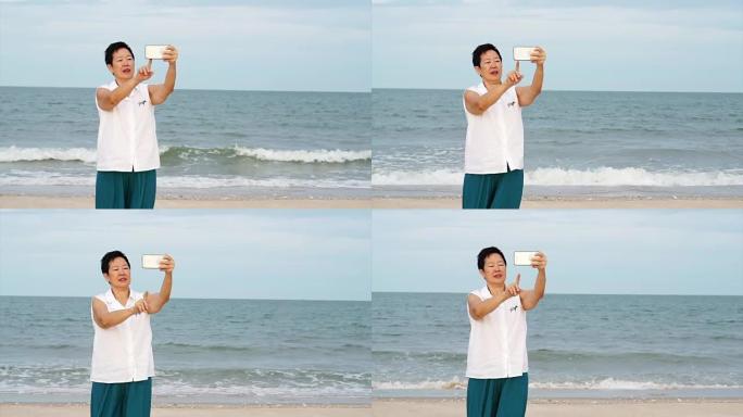 亚洲高级女性在海边放松和交谈自拍照