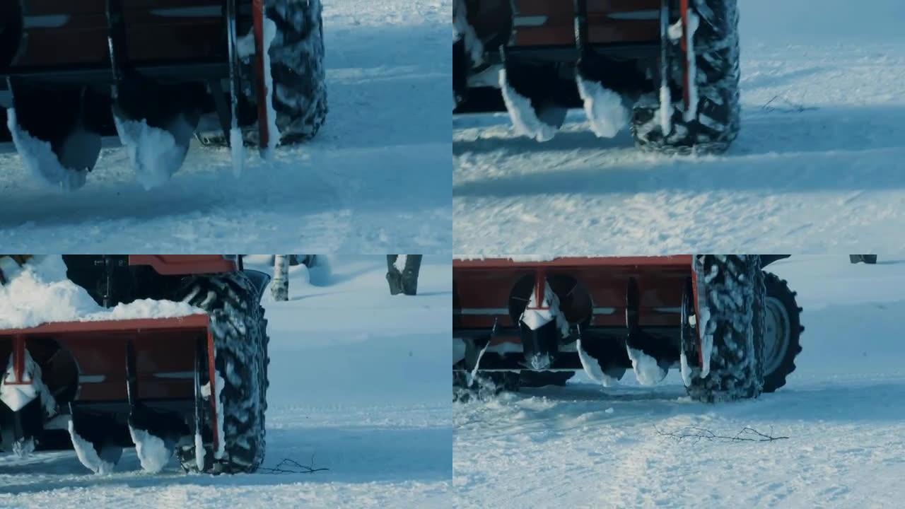 带有链条的拖拉机车轮在深雪中运动