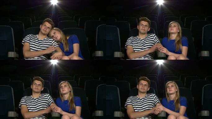 年轻夫妇在电影院互相喂食