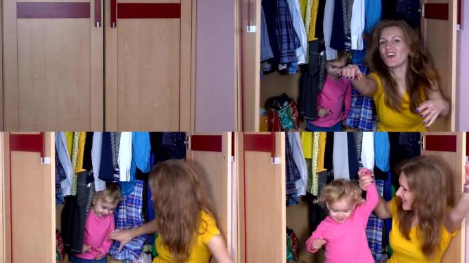 藏在衣橱里的漂亮女孩。母女打开衣柜微笑