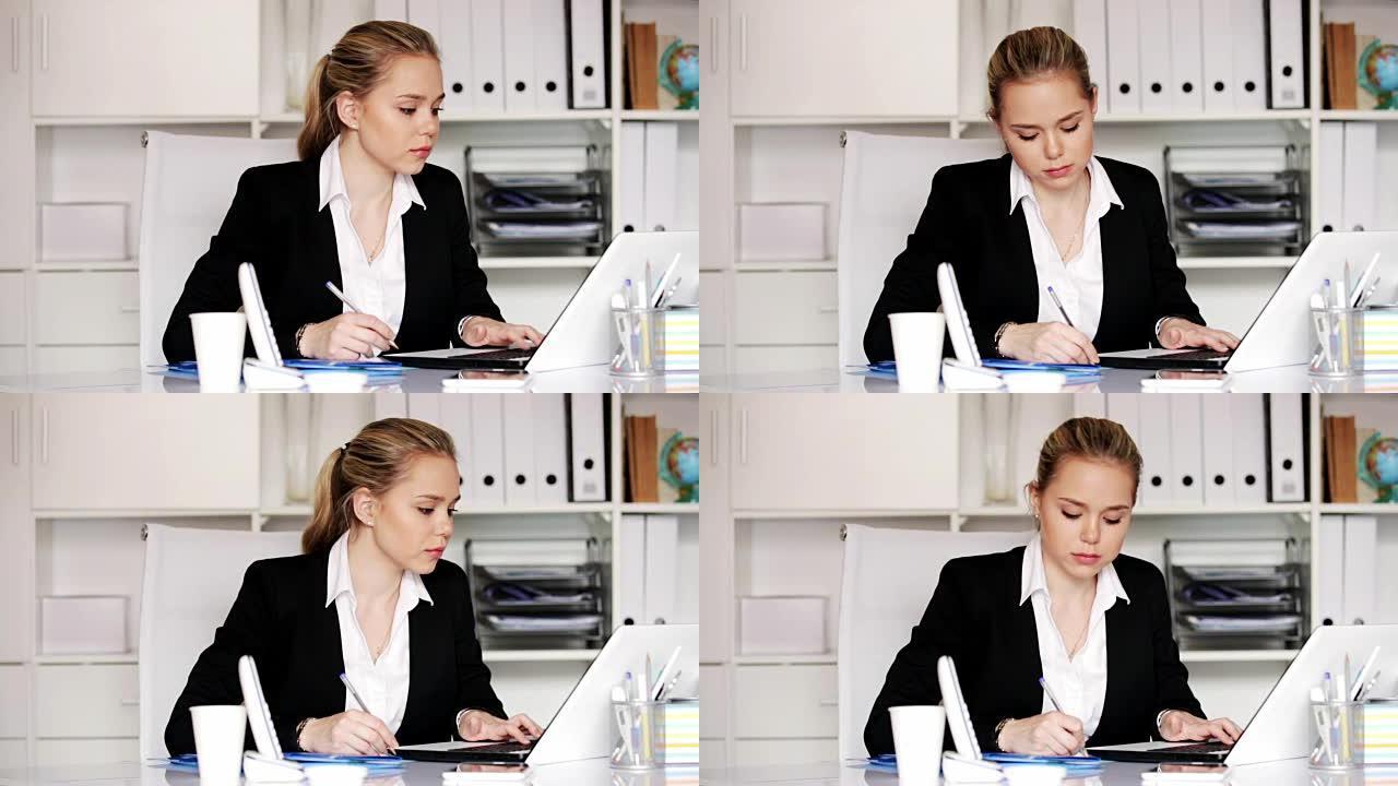 在办公室用笔记本电脑工作的女人