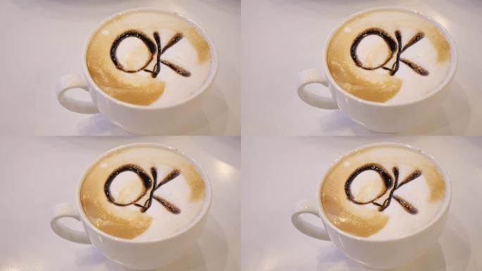 咖啡师在白杯上画巧克力艺术咖啡拿铁
