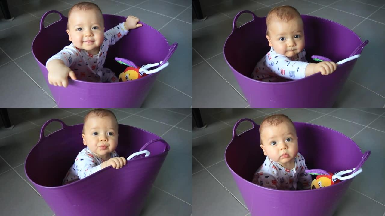 婴儿在紫色洗衣篮中玩耍