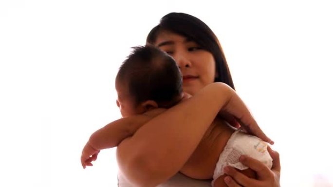 亚洲年轻漂亮的母亲用爱亲吻她的小宝宝