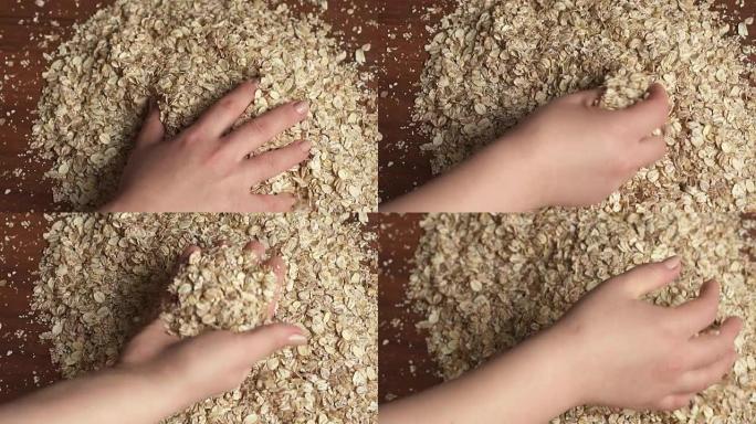 特写女孩手里拿着燕麦片，慢动作。