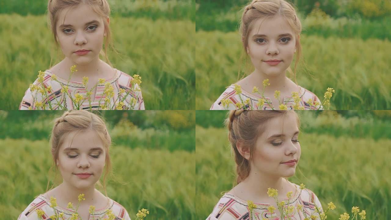 可爱的年轻女孩拿着一束油菜花，在田野里摆姿势