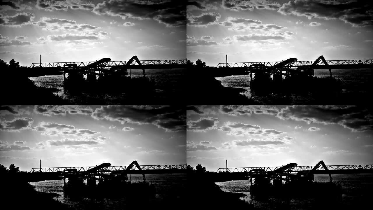 黑暗中河上的桥梁和驳船
