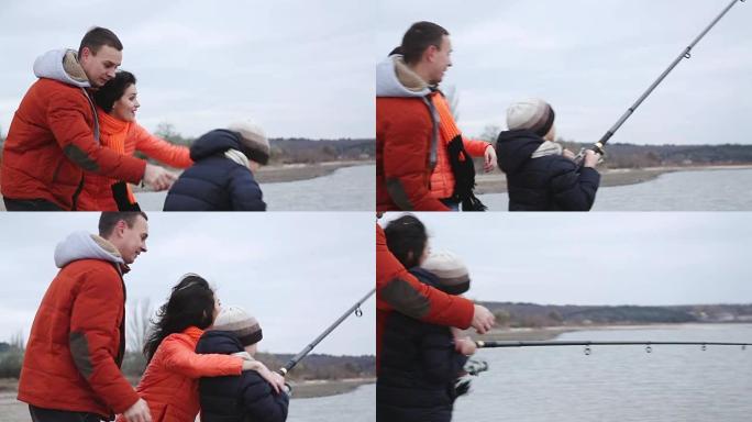 钓鱼男孩抓鱼。爸爸妈妈正在帮忙把鱼从湖里捞出来。