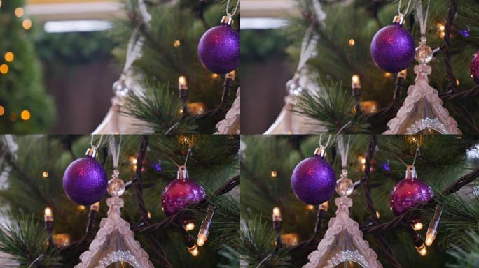 一棵装饰有紫色球的圣诞树的4k镜头，镜头从左向右移动