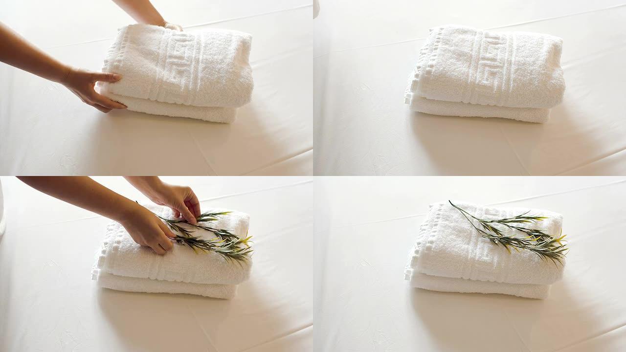 床上有橄榄枝的干净毛巾