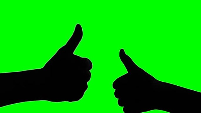 绿色屏幕背景上双手竖起大拇指的剪影