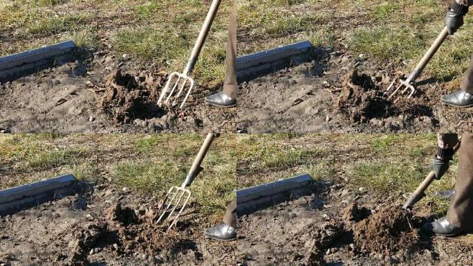 用干草叉在花园里挖泉水土