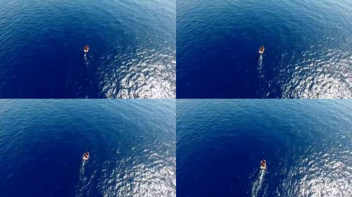 空中: 蓝色海中的摩托艇，里面有人