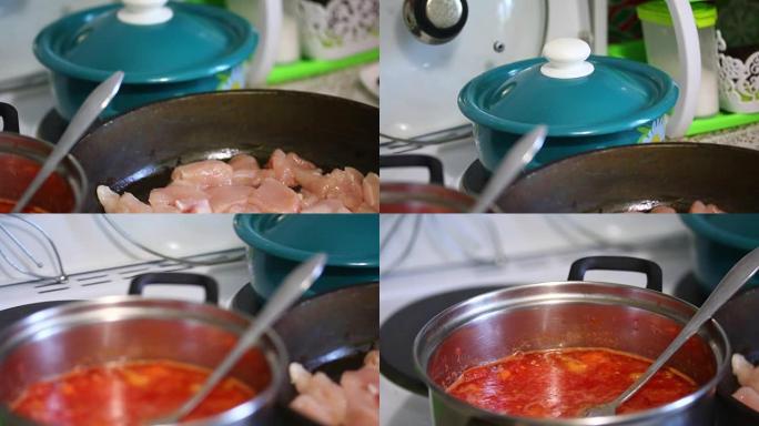 番茄汤的制备。炉子上有一锅西红柿和西红柿，还有一个装有鸡片的煎锅。