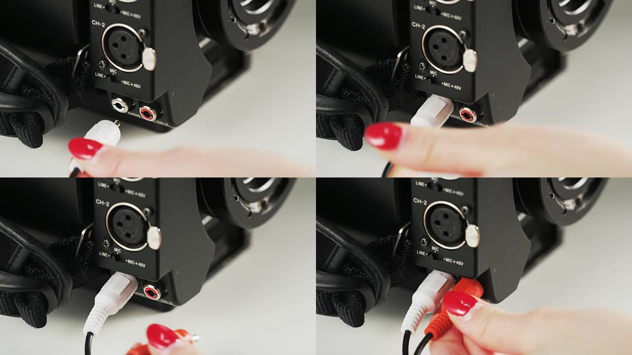 女人将红色和白色电缆插入相机