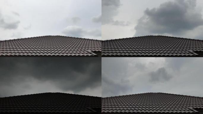 在屋顶房屋模糊的大雨之前，乌云的时间流逝
