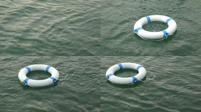一个白色的安全浮标被扔进水中并流入水中