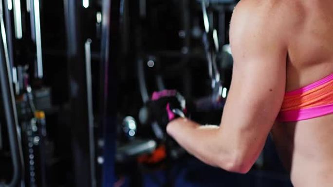 运动的女人训练手部肌肉，可以看到肱三头肌和肌肉发达的肩膀。女性健美