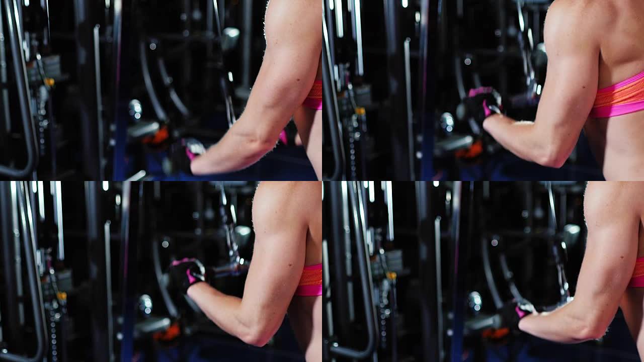 运动的女人训练手部肌肉，可以看到肱三头肌和肌肉发达的肩膀。女性健美