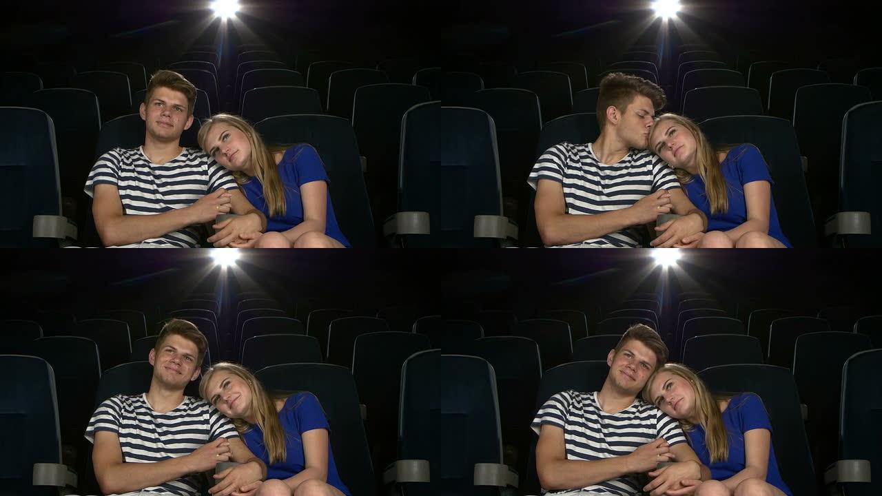 伟大的电影!年轻夫妇在电影院互相喂食