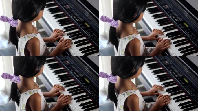 亚洲女孩学习弹钢琴