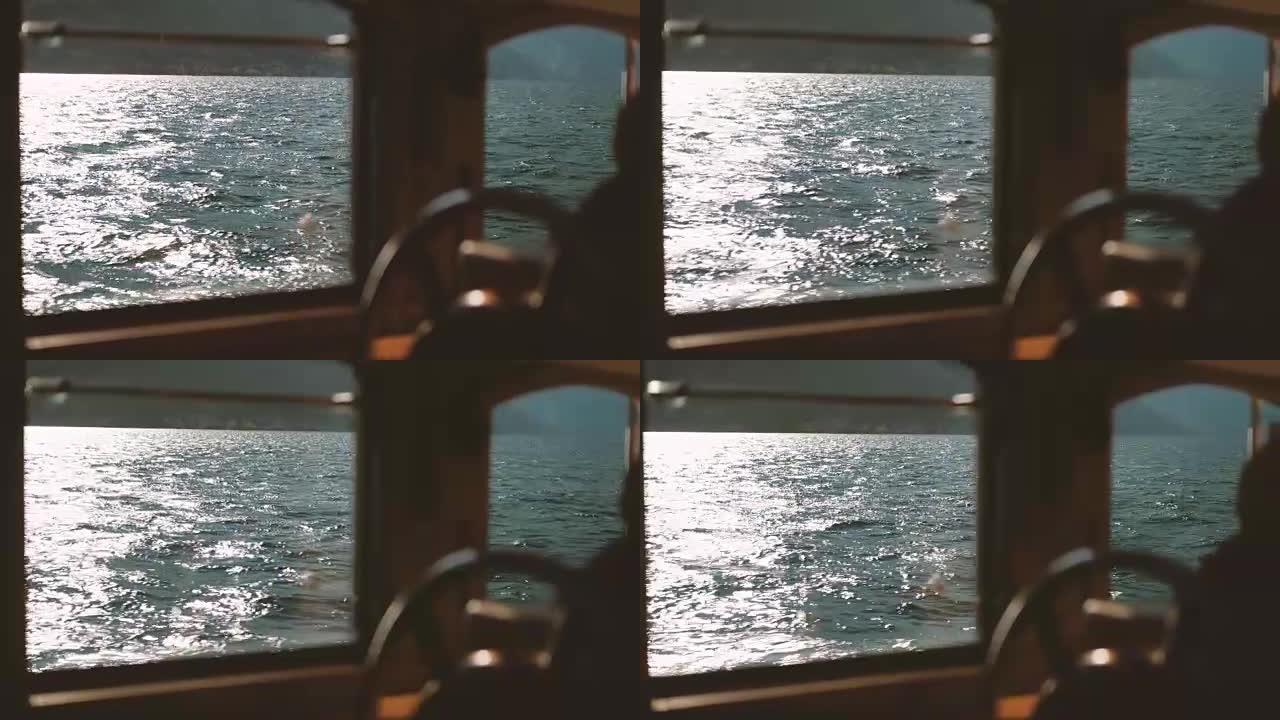从游艇窗口，您可以看到太阳反射的大海