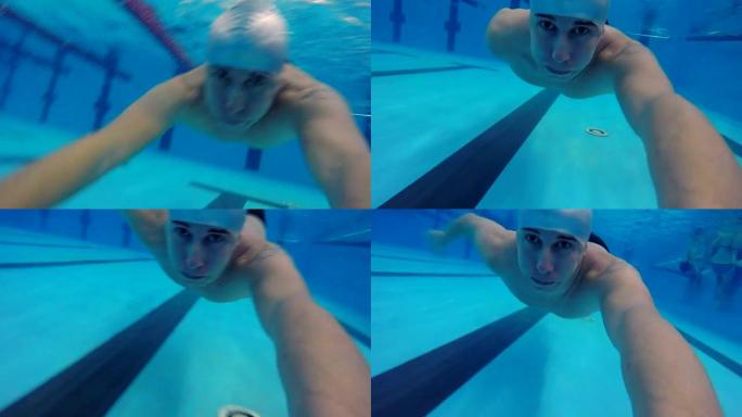 男子潜入游泳池在水下游泳