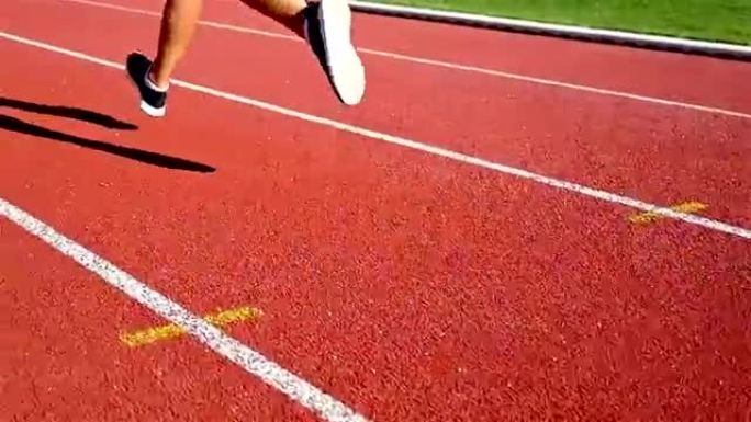 跟踪跑道运动员女子跑步的鞋子的摄像机