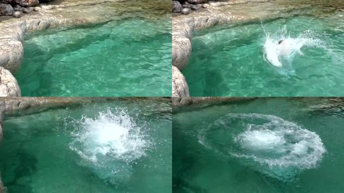 高清超级慢动作-女孩从岩石跳到海里。