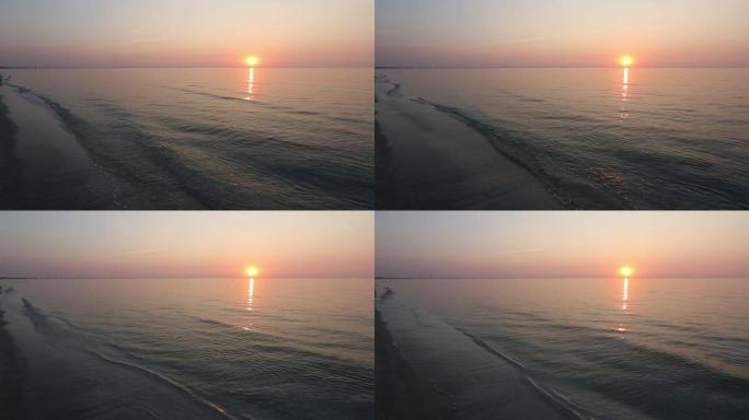 太阳升起在海面、太阳轨道和沙滩上。