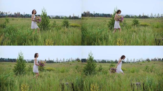 美丽的受启发的女人在一束野花盛开的田野上说话